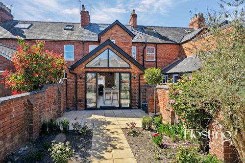 an extension to a house with a brick wall at Number Ten - Beautiful 3-Bedroom Luxury Home in Henley on Thames
