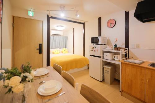 a room with a dining table and a bedroom at 鹤の泊 in Osaka