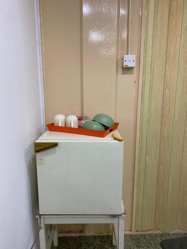 a white cabinet with dishes on top of it at Pok Mat Beach Cabin in Marang