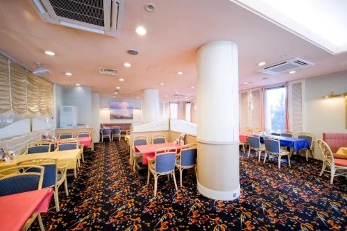 a restaurant with tables and chairs in a room at Yuzawa Royal hotel in Yuzawa