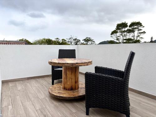 a table and two chairs on a patio at Azores Homes Resort & Spa in Ponta Delgada