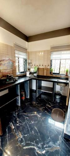 a kitchen with a marble floor and a counter top at Green House Stay in Mandrem