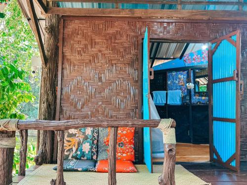 a wooden bench sitting in front of a room at Baan Suanthip Homestay - Aoluek Natural Retreat in Ao Luk