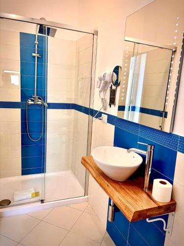 a bathroom with a sink and a shower at Don Nicola Tourist Location in Polignano a Mare