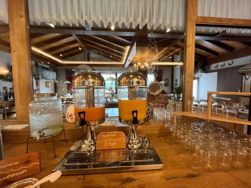 a bar with glasses and two juicerlords on a counter at Landhotel Spessartruh in Frammersbach