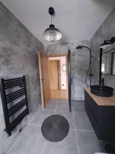 a bathroom with a black sink and a mirror at Chalet Habovka in Habovka