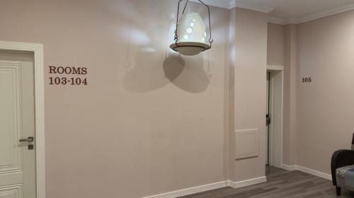 a hallway with a light fixture on the wall at Nemi Museum Art Hotel in Baku