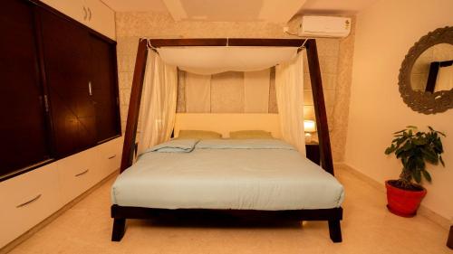 a bedroom with a bed with a canopy at Luho 6 off Sarjapur Road in Bengaluru