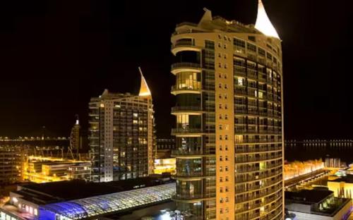 a tall building in a city at night at Caravela - Torre Sao Rafael in Lisbon