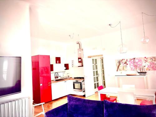 a living room with a blue couch and a kitchen at Don Nicola Tourist Location in Polignano a Mare