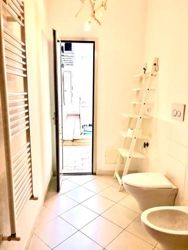 a bathroom with a toilet and a ladder in it at Don Nicola Tourist Location in Polignano a Mare