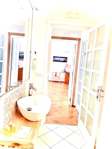 a bathroom with a white sink and a mirror at Don Nicola Tourist Location in Polignano a Mare