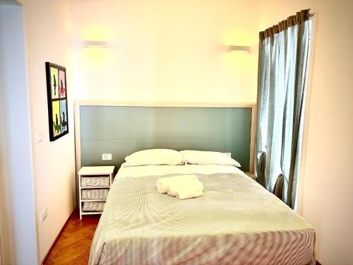a bedroom with a large bed with two towels on it at Don Nicola Tourist Location in Polignano a Mare