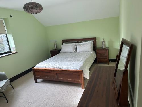 a bedroom with a bed with white sheets and pillows at Matilda house in Ferbane