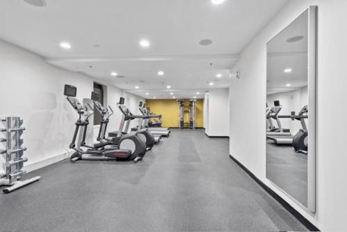 a gym with rows of treadmills and elliptical machines at KOT suites Inner Harbor in Baltimore