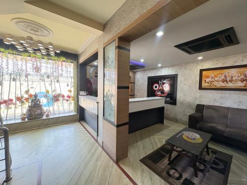 a living room with a couch and a table at Hotel Benson Blue In Cuttack in Cuttack