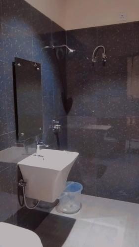 a bathroom with a sink and a toilet at neo in Dhūlkot