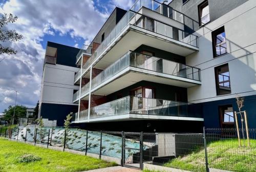 a building with balconies on the side of it at Apartament Klonova z tarasem in Olecko