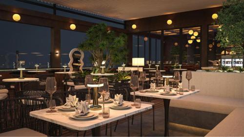 a restaurant with tables and chairs in a restaurant at Oakwood Hotel & Apartments Saigon in Ho Chi Minh City
