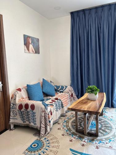 a living room with a couch and a table at The Western Capital Apartment, Eric House in Ho Chi Minh City