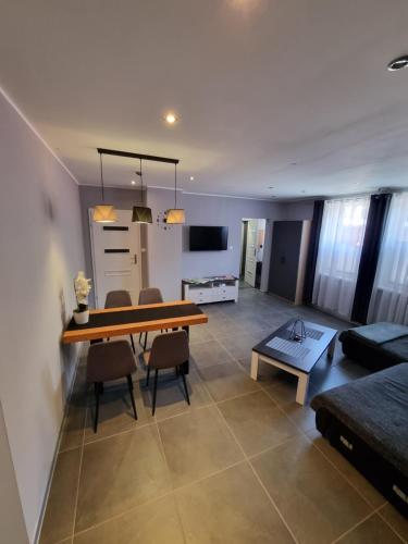 a living room with a table and chairs and a couch at Apartament exclusive Głuszyca in Głuszyca