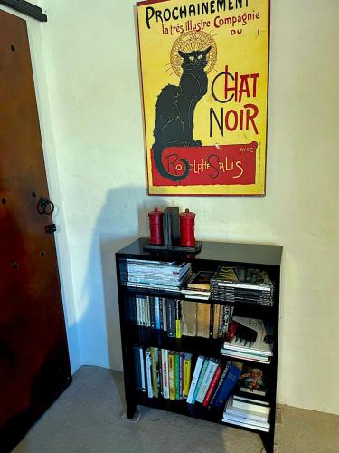 a book shelf with books and a poster on the wall at Mount Road Suites in Port Elizabeth