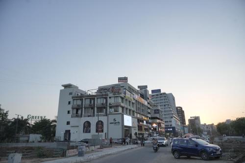 a city street with cars and a building at Hotel The Grand View,Gandhinagar in Gandhinagar