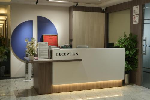 an reception desk in an office with a reception counter at Hotel The Grand View,Gandhinagar in Gandhinagar