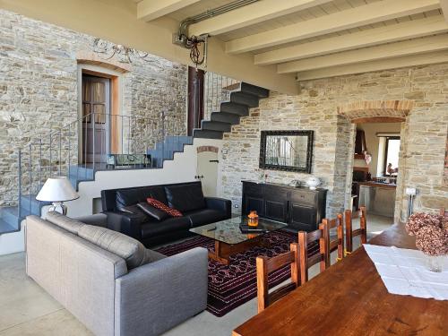 a living room with a couch and a fireplace at Sogni nel Bosco in Varsi