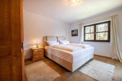 Un dormitorio con una cama grande y una ventana. en Sonnenschein, en Garmisch-Partenkirchen
