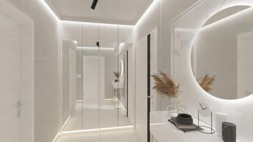 a white bathroom with a sink and a mirror at Royal Blue & Royal Green in Opole