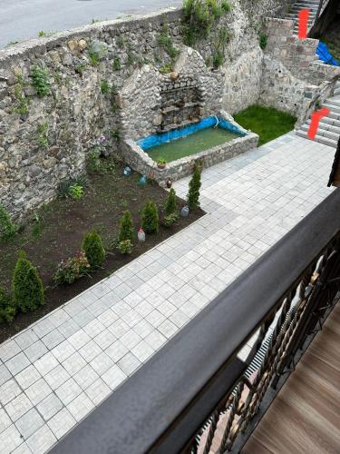 an aerial view of a garden next to a stone wall at Dom Adonis in Dilijan