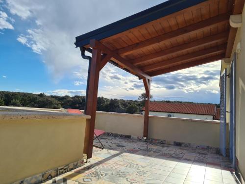 a pergola on a balcony with a view at Apartment Salvia - Stivan, Cres - 900 m to Merascica beach in Štivan