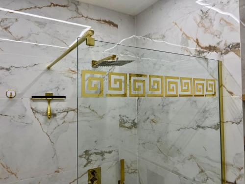 a bathroom with a shower with marble walls at VIP GOLD Warszawa Parking FREE in Stefanowo