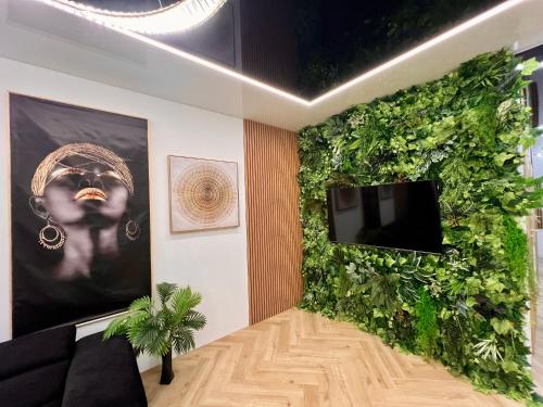 a living wall in a living room with a tv at VIP GOLD Warszawa Parking FREE in Stefanowo