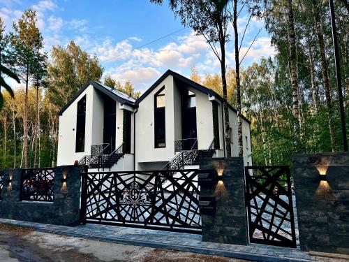 a house with a black and white fence at VIP GOLD Warszawa Parking FREE in Stefanowo