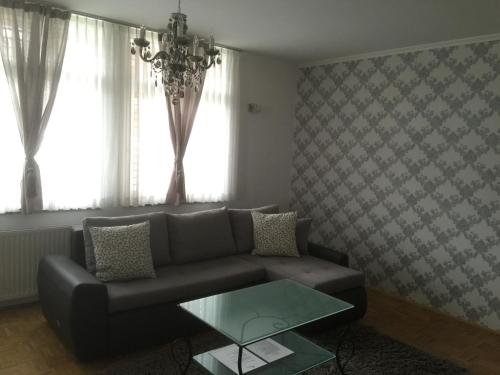 a living room with a couch and a glass table at Apartments Vila Cvetka Bled in Bled