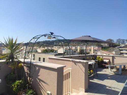 a balcony with an umbrella and a view of a city at DolceVita Home in Civitanova Marche
