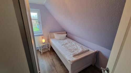 Ένα ή περισσότερα κρεβάτια σε δωμάτιο στο Ferienhaus Wattwurm