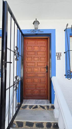 a brown garage door with a sign on it at Villa Nina in Mazarrón