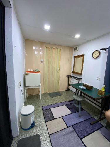 a room with a table and a mirror on the wall at Pok Mat Beach Cabin in Marang