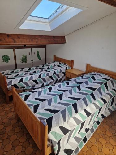 - une chambre avec 2 lits et une lucarne dans l'établissement maison à louer, à Saint Cyprien Plage