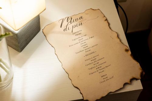 a menu on a table next to a lamp at La Finestra d'Arezzo in Arezzo