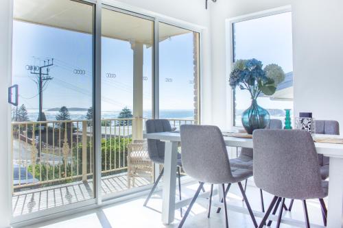 a dining room with a table and chairs and a balcony at Pet & Family Friendly 3BR Coastal Escape Near Boat Ramp - Diyamba! in Encounter Bay