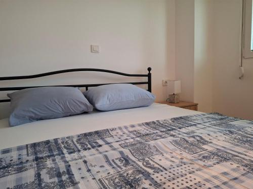a bedroom with a bed with two pillows on it at Milani Apartment Gevgelija in Gevgelija