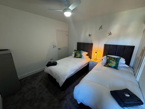a room with two beds in a room at Park view holiday apartment in Skegness