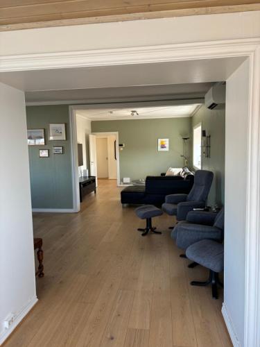 a living room with a couch and chairs in it at Brygga i Helgeroa in Larvik