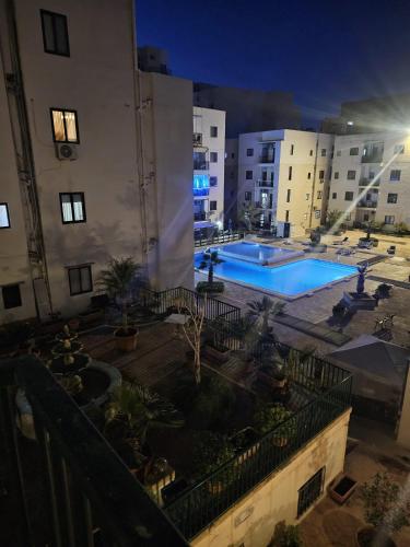 a view of a pool from a balcony of a building at Apartment with pool in St. Paul's Bay