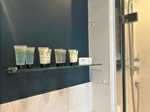a shelf with a bunch of toothbrushes in a bathroom at Orla Restaurant & Rooms in Lindfield