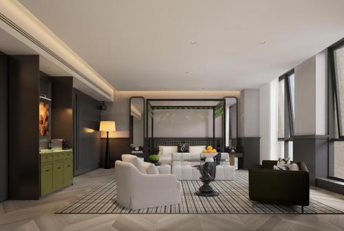 a living room with white furniture and a large mirror at 重庆Indition英迪逊酒店江北嘴金融城店 in Chongqing